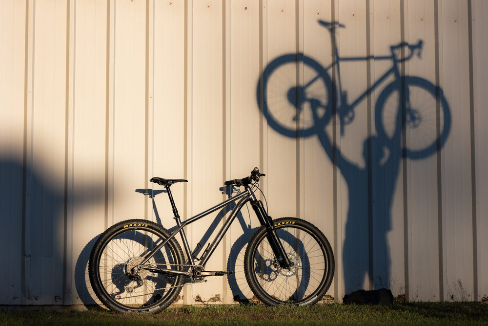 man holding up a bike