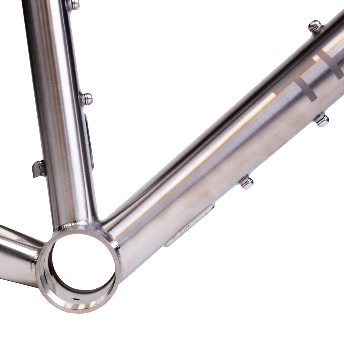 A silver Thomson bicycle frame with black fork, displayed on a white background.