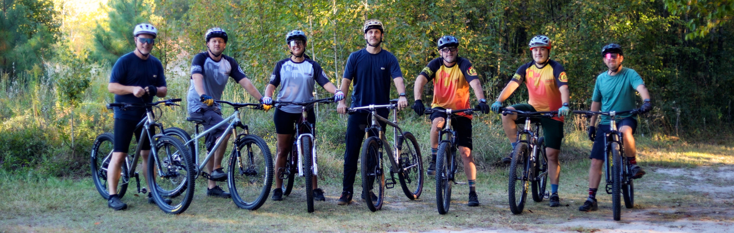 horizontal image showing Thomson team all on bikes smiling