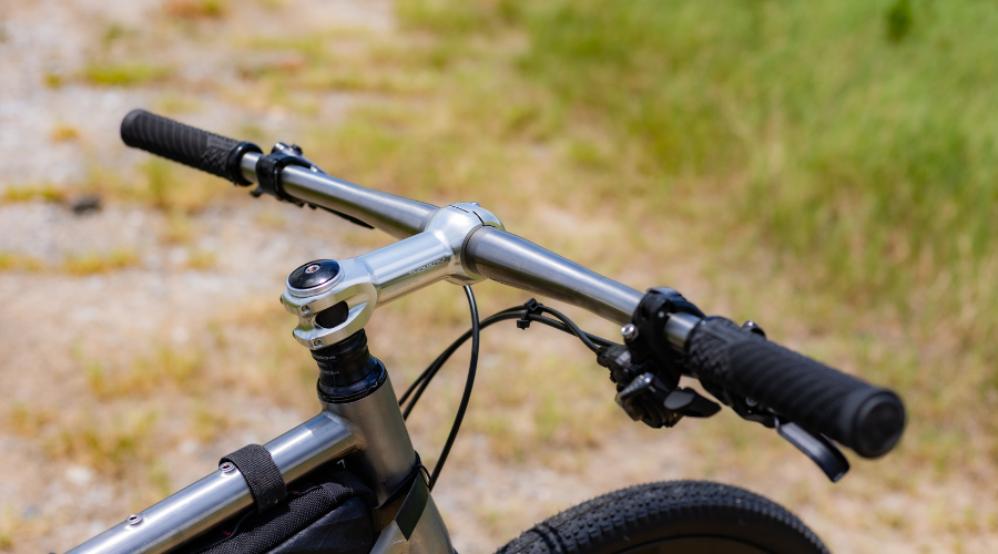 side view of thomson Ti handlebar with grass in background