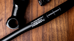 birds-eye view image of carbon handlebar on wood surface