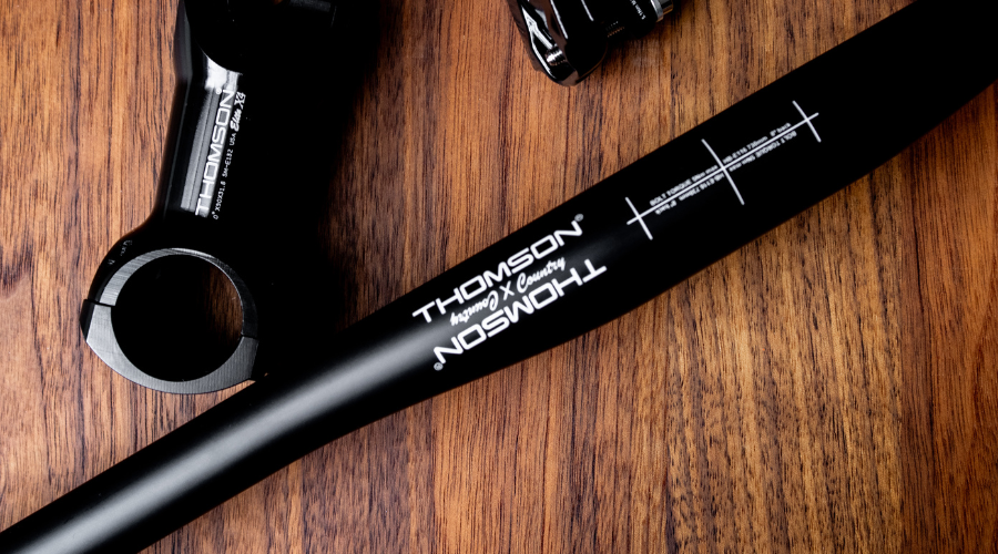 birds-eye view image of carbon handlebar on wood surface