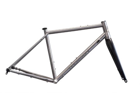 A silver Thomson bicycle frame with black fork, displayed on a white background.