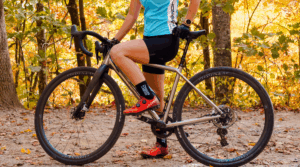 female riding a titanium gravel bike