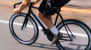 motion shot of male riding bike